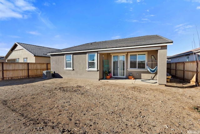 rear view of property with central AC unit