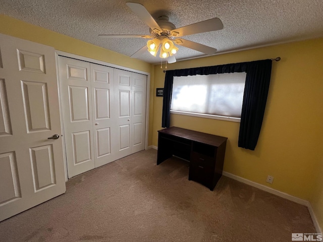 bedroom featuring ceiling fan, a closet, carpet, and a textured ceiling