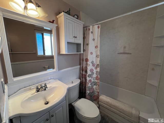 full bathroom featuring shower / bath combination with curtain, vanity, and toilet