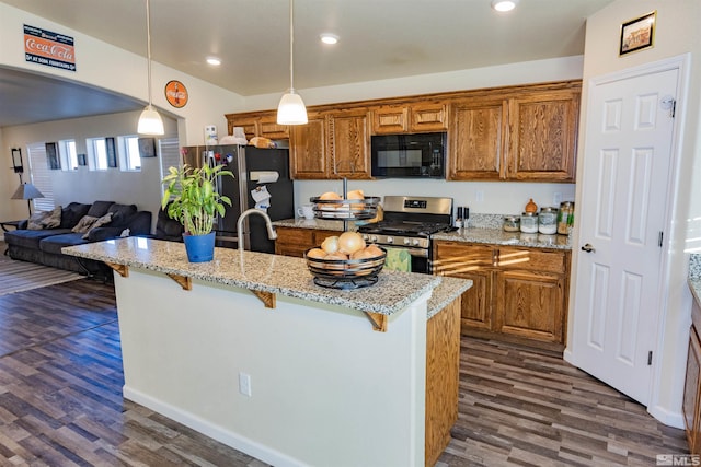 kitchen featuring decorative light fixtures, dark hardwood / wood-style floors, a breakfast bar area, and appliances with stainless steel finishes