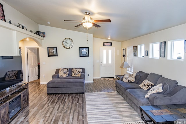 living room with vaulted ceiling, ceiling fan, and hardwood / wood-style floors