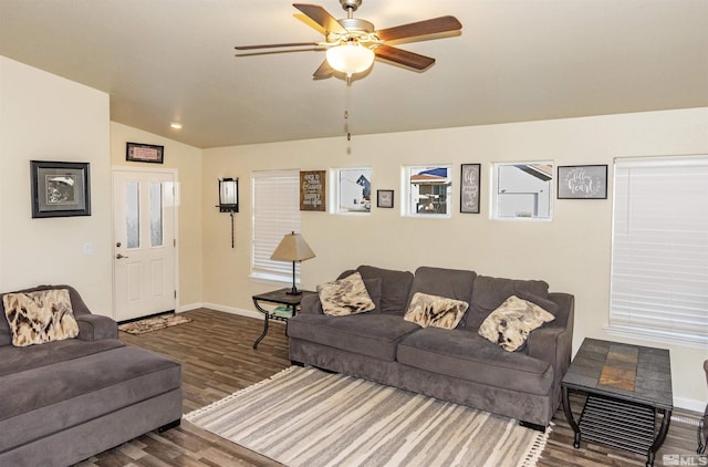 living room featuring ceiling fan, dark hardwood / wood-style floors, and lofted ceiling