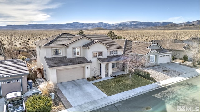 view of front facade with a mountain view and a garage