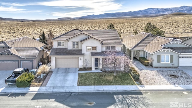 view of front property with a mountain view and a garage