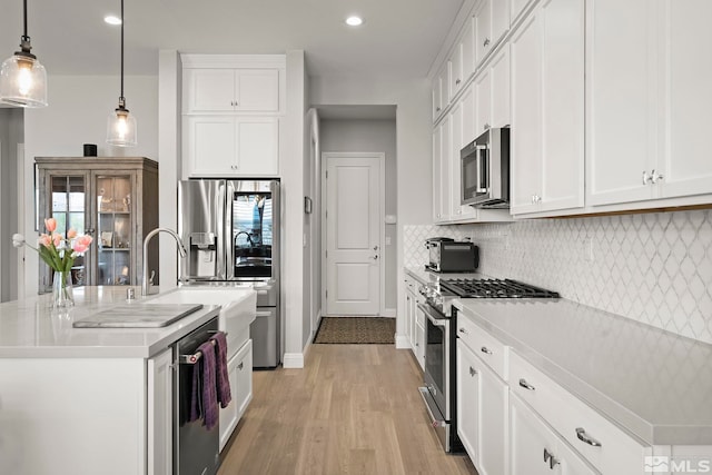 kitchen featuring white cabinetry, a kitchen island with sink, and stainless steel appliances