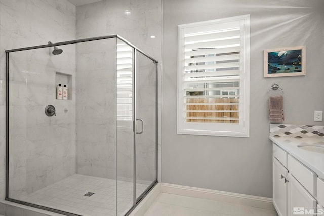 bathroom with tile patterned floors, vanity, and walk in shower