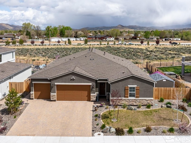 view of front facade with a mountain view and a garage