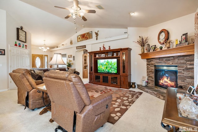 carpeted living room featuring a fireplace, ceiling fan with notable chandelier, and lofted ceiling