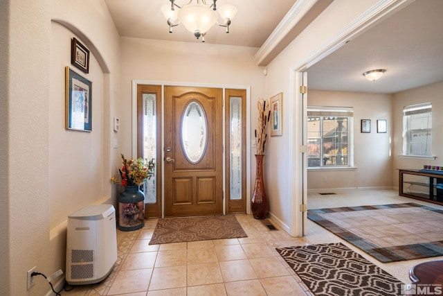 entrance foyer featuring light tile patterned floors and a chandelier