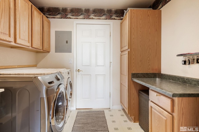 clothes washing area with washer and clothes dryer, cabinets, and electric panel