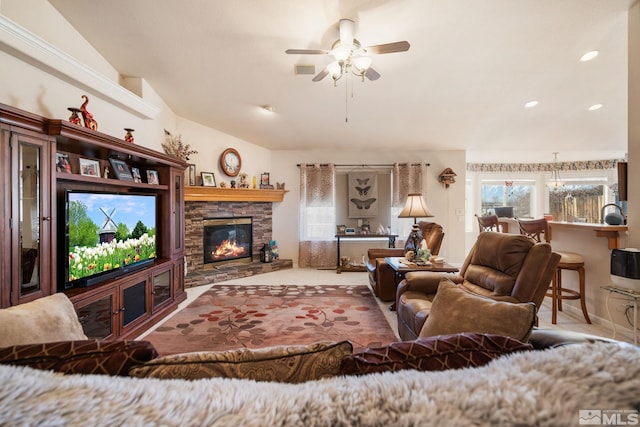 living room featuring a fireplace, vaulted ceiling, and ceiling fan