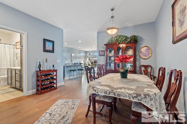 dining space featuring wood-type flooring