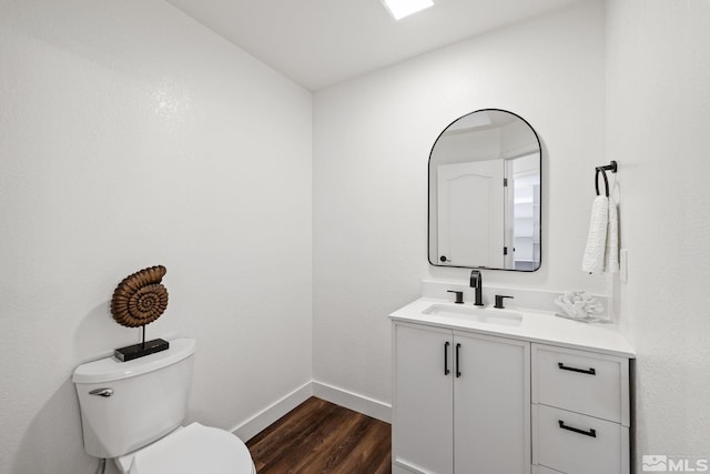 bathroom featuring hardwood / wood-style floors, vanity, and toilet