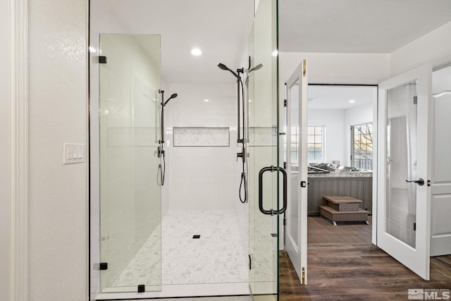 bathroom with hardwood / wood-style floors and walk in shower