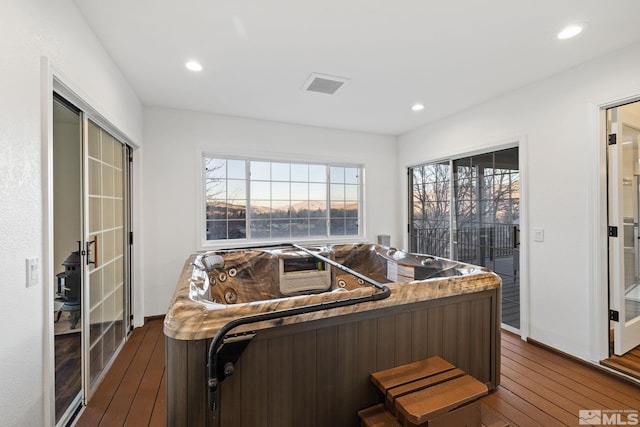 interior space with dark hardwood / wood-style flooring and a breakfast bar area