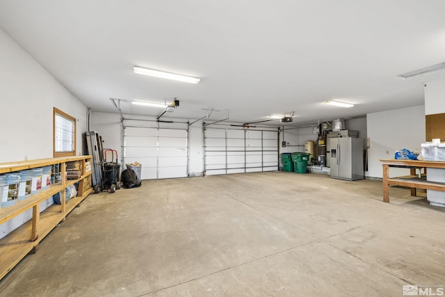 garage with stainless steel fridge with ice dispenser and a garage door opener