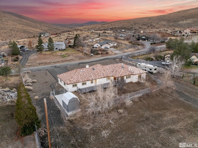 aerial view at dusk featuring a mountain view