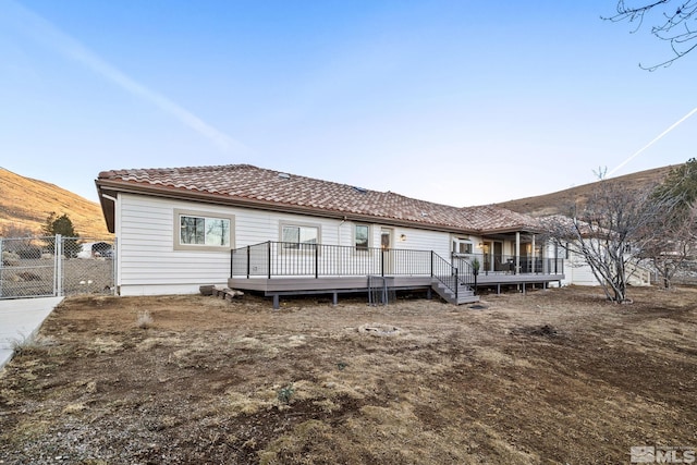 back of house featuring a wooden deck