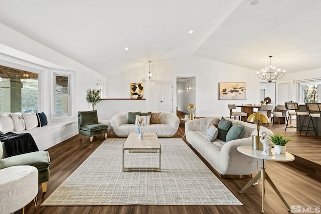 living room featuring lofted ceiling, a chandelier, and dark hardwood / wood-style floors