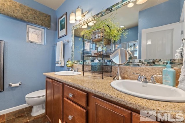 bathroom featuring tile patterned floors, vanity, and toilet