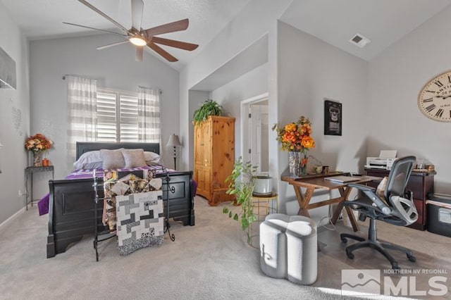 carpeted bedroom with ceiling fan and vaulted ceiling