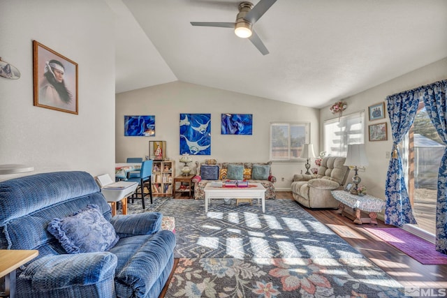 living room featuring ceiling fan, hardwood / wood-style floors, and vaulted ceiling