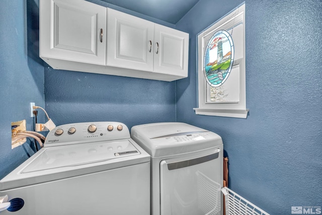 washroom with cabinets and independent washer and dryer