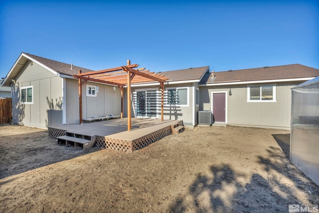 back of house with a deck, a pergola, and central AC