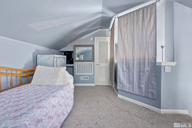 carpeted bedroom featuring lofted ceiling