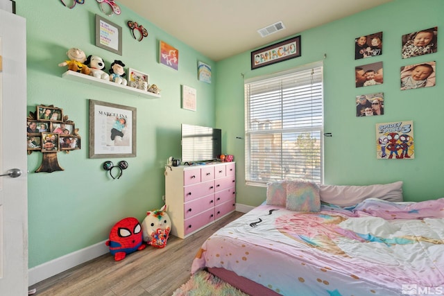 bedroom with wood-type flooring