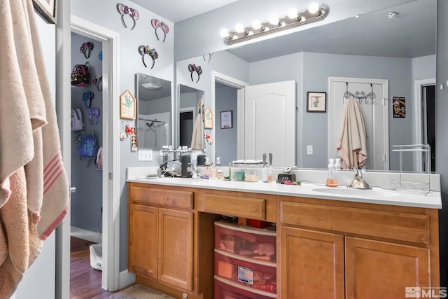 bathroom with hardwood / wood-style floors and vanity