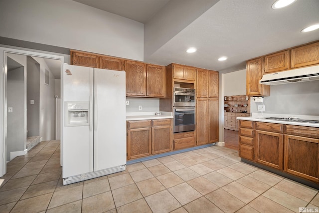 kitchen with light tile patterned flooring and white appliances