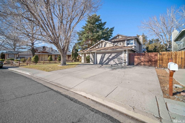 view of front of house featuring a garage and a front lawn