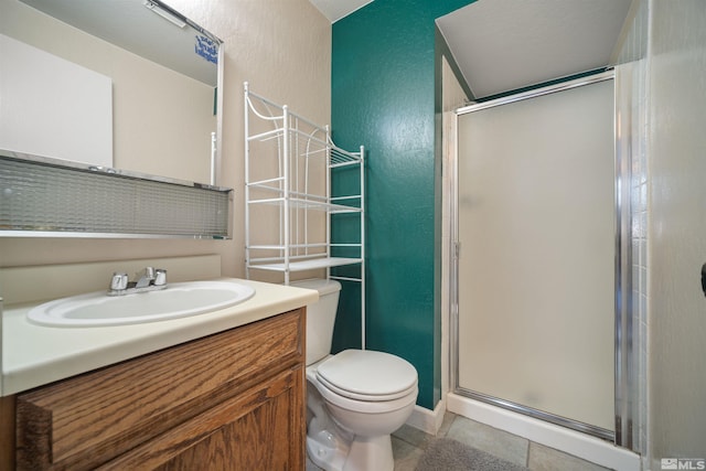 bathroom featuring tile patterned flooring, vanity, toilet, and a shower with shower door