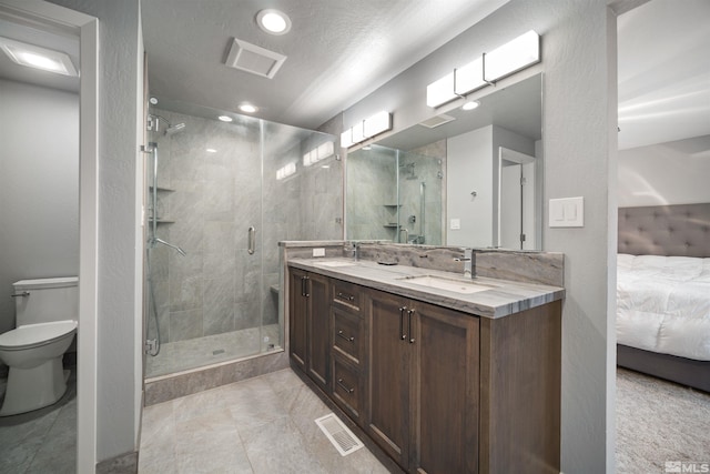 bathroom featuring toilet, vanity, and walk in shower