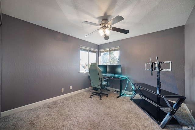 home office with carpet, ceiling fan, and a textured ceiling