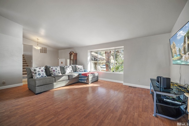 living room featuring lofted ceiling and wood-type flooring