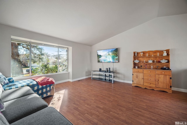 living room featuring dark hardwood / wood-style flooring and vaulted ceiling