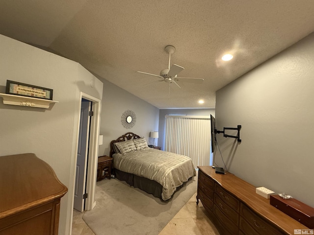 tiled bedroom featuring a textured ceiling and ceiling fan