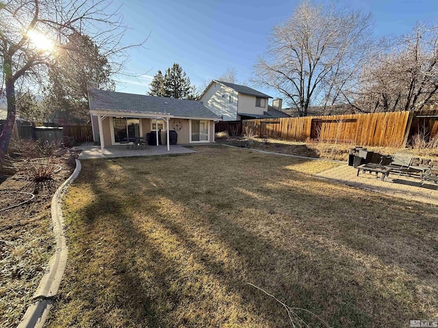 back of property featuring a patio area and a yard