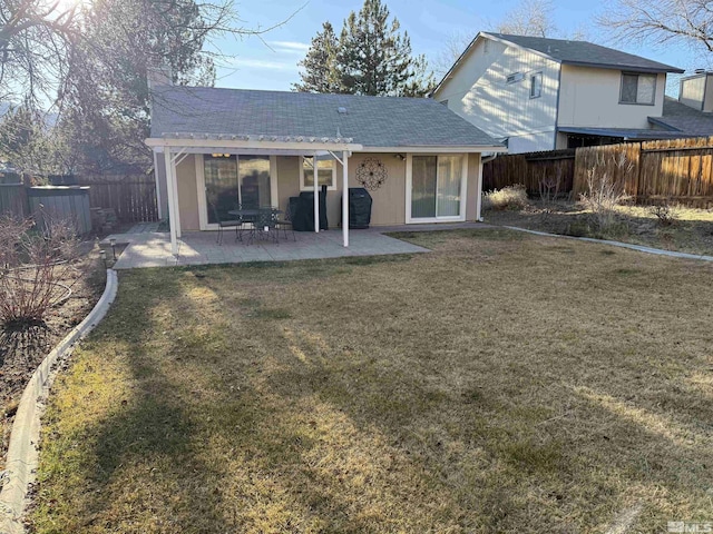 back of property featuring a lawn and a patio