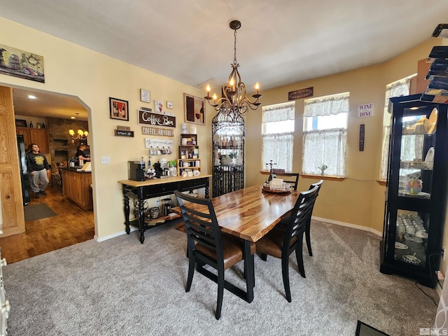 dining area featuring carpet flooring and a notable chandelier