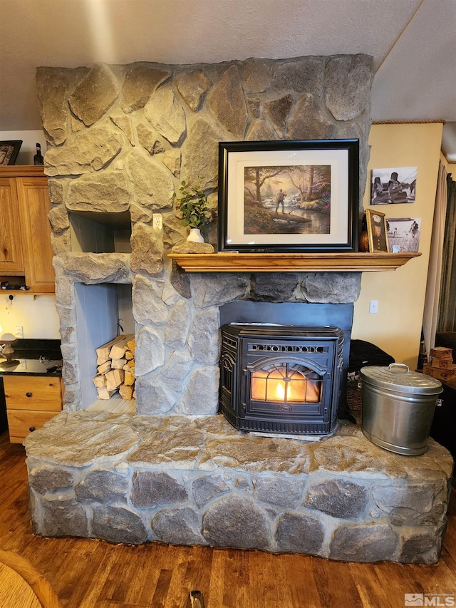 room details with wood-type flooring and a wood stove