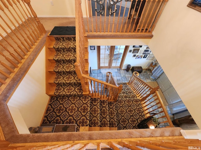 staircase featuring a high ceiling