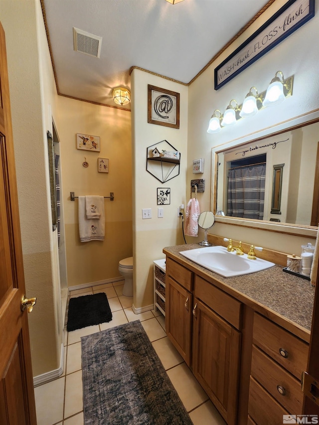 bathroom featuring tile patterned floors, vanity, and toilet