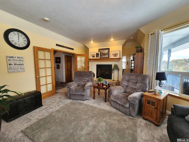 living room with carpet flooring, french doors, and a textured ceiling