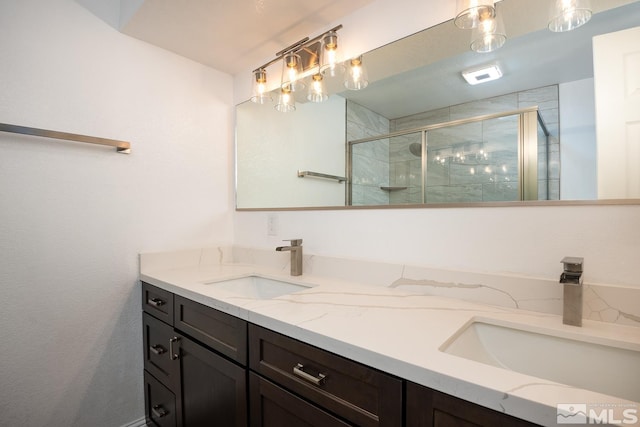 bathroom with vanity and a shower with shower door