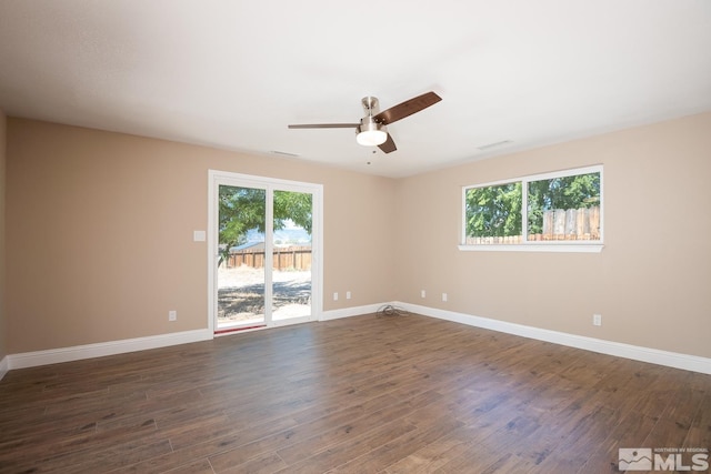 spare room featuring ceiling fan and dark wood-type flooring