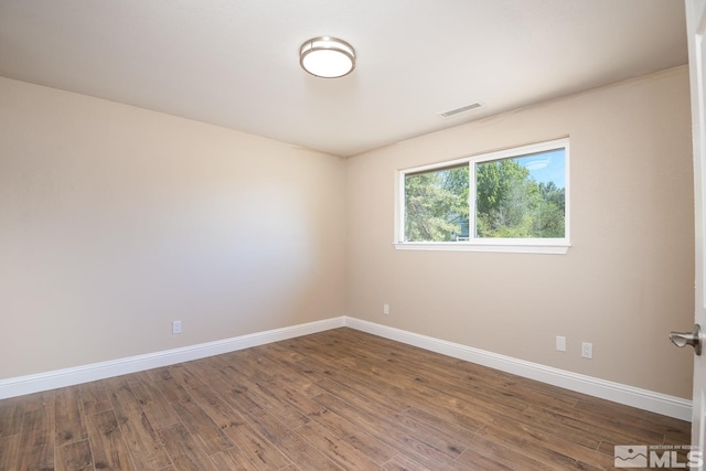 unfurnished room with wood-type flooring