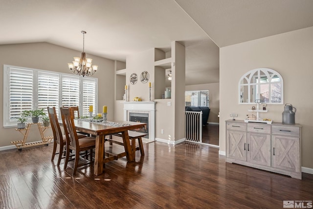 dining area featuring a chandelier, dark hardwood / wood-style floors, a wealth of natural light, and lofted ceiling